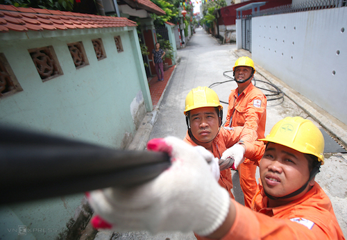 Công nhân điện lực Hà Nội sửa chữa đường dây điện sinh hoạt tại quận Long Biên. Ảnh: Ngọc Thành